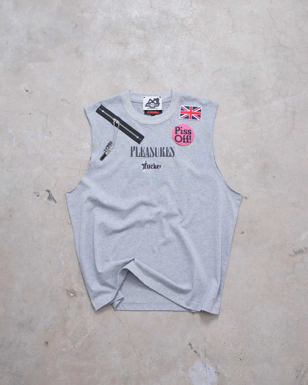 Gray sleeveless shirt with text and graphics on a concrete surface